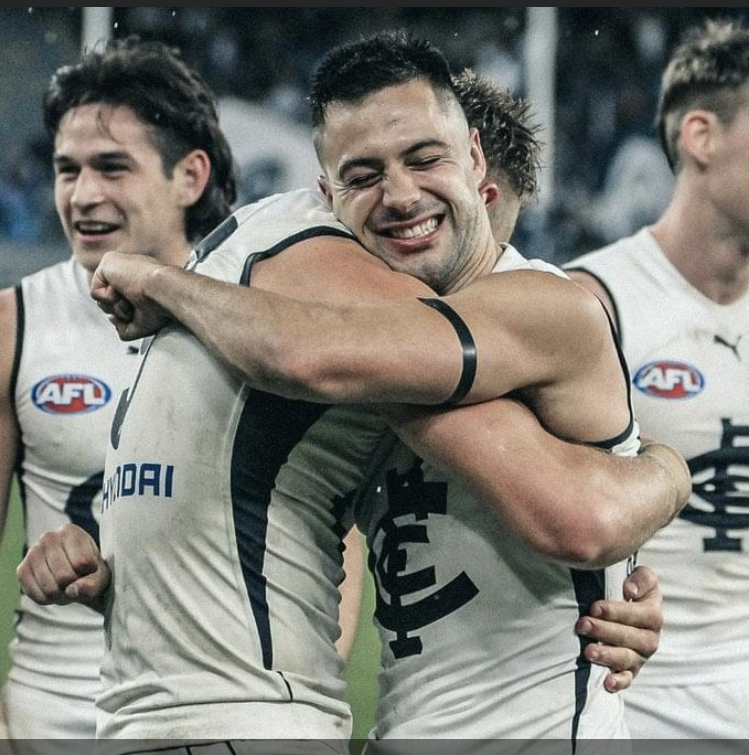 2020 Rd 12 - An ecstatic Newnes & Gibbons hug with Fisher in the background.